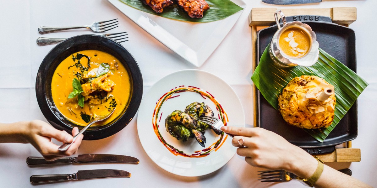 hands cutting into food at Veeraswamy