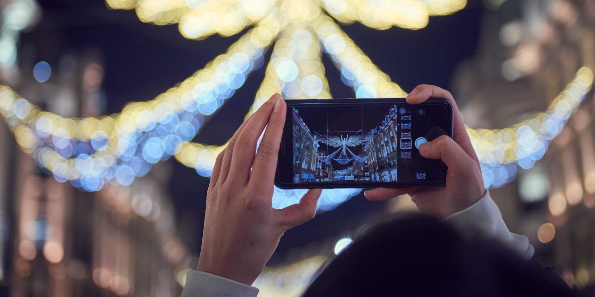 Person taking a photo of the Christmas lights