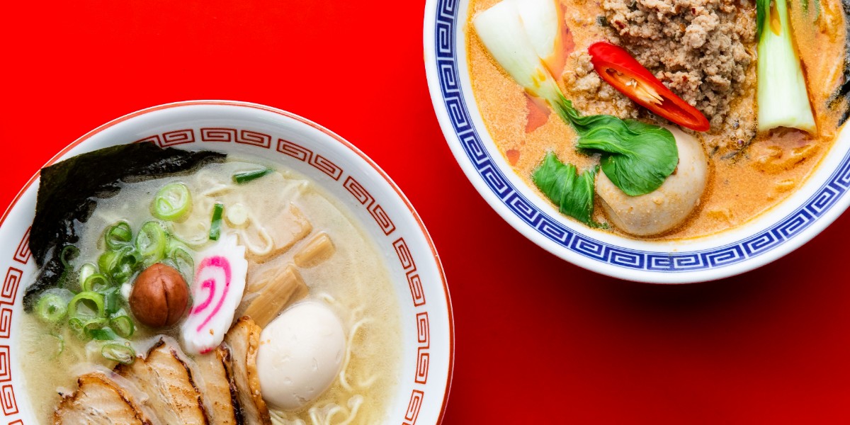 Two bowls of Heddon Yokocho ramen on a red table