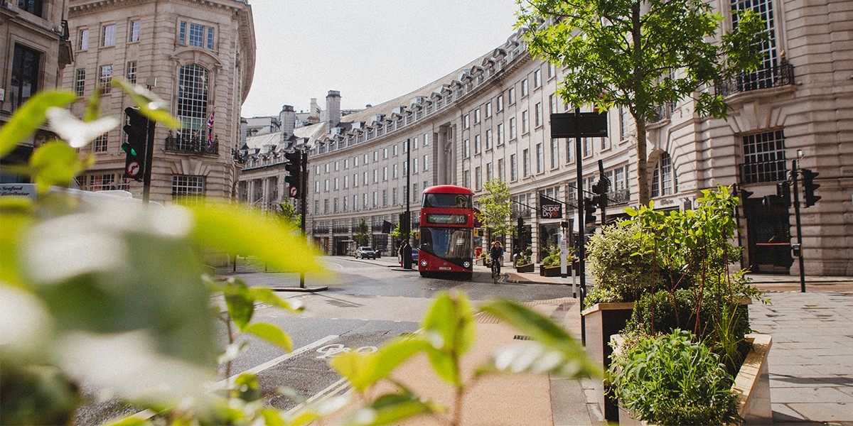 cars and buses driving along Regent Street